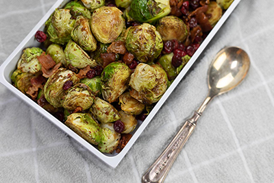 Balsamic Brussels Sprouts with Cranberries and Bacon in White Serving Dish