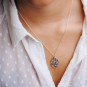 Sterling silver hummingbird and flower necklace on neck