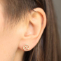 Solid 14K Gold wave post earrings on ear