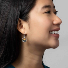 Silver Circle Mountain Earrings with Bronze Sun on model