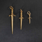 Three sizes of bronze sword charms