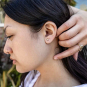 Bronze Mini Skull Post Earrings 6x5mm on ear