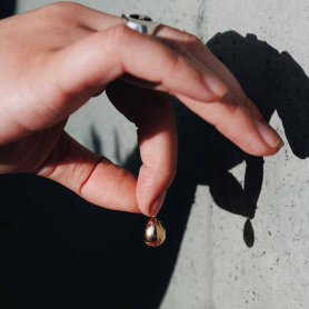 Bronze Golden Egg Charm 19x10mm in hand