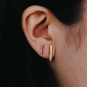 2 sizes of  bronze bar earrings on ear