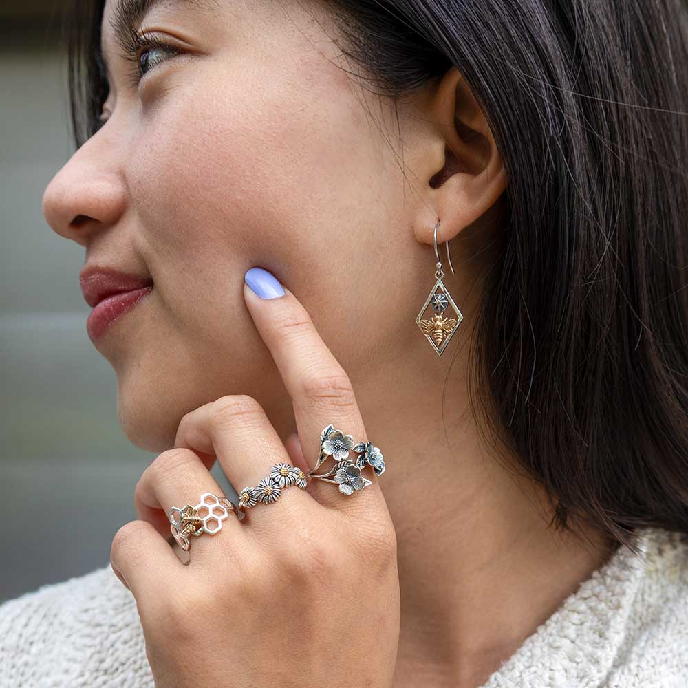 Women wearing silver flower jewelry