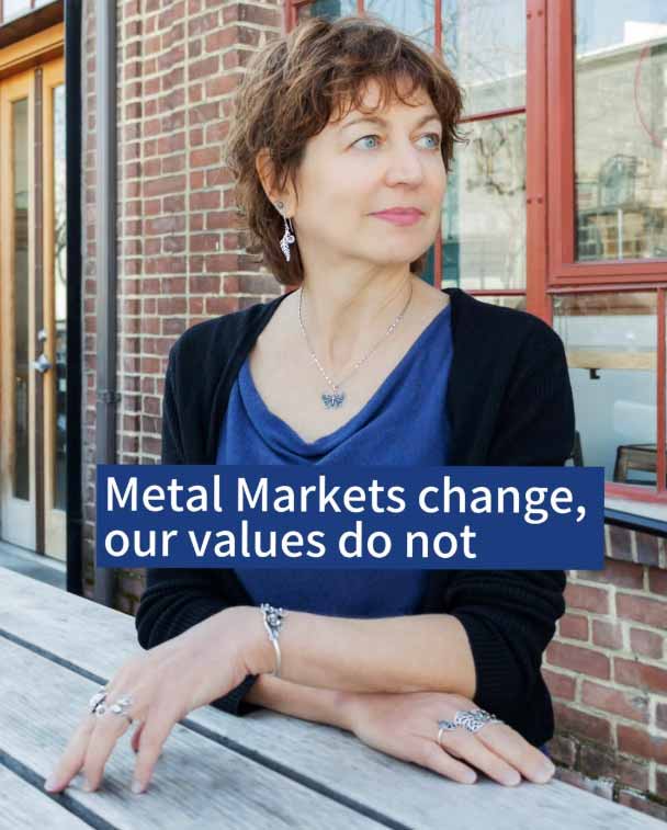 Woman Standing with text saying Metal Markets Change, Our Values Do Not