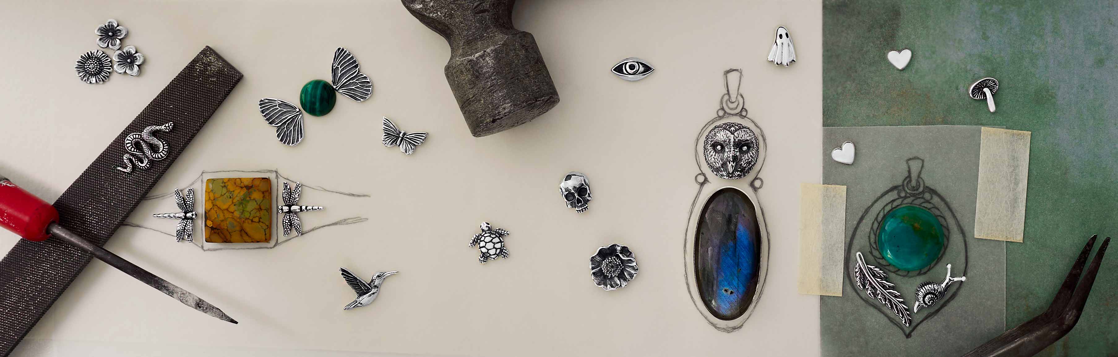 Sterling Silver Solderable Charms scattered on table