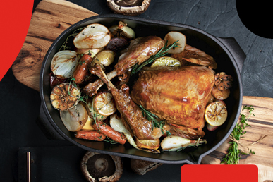 AMT roasting dish with large roasted chicken, onions and garnish