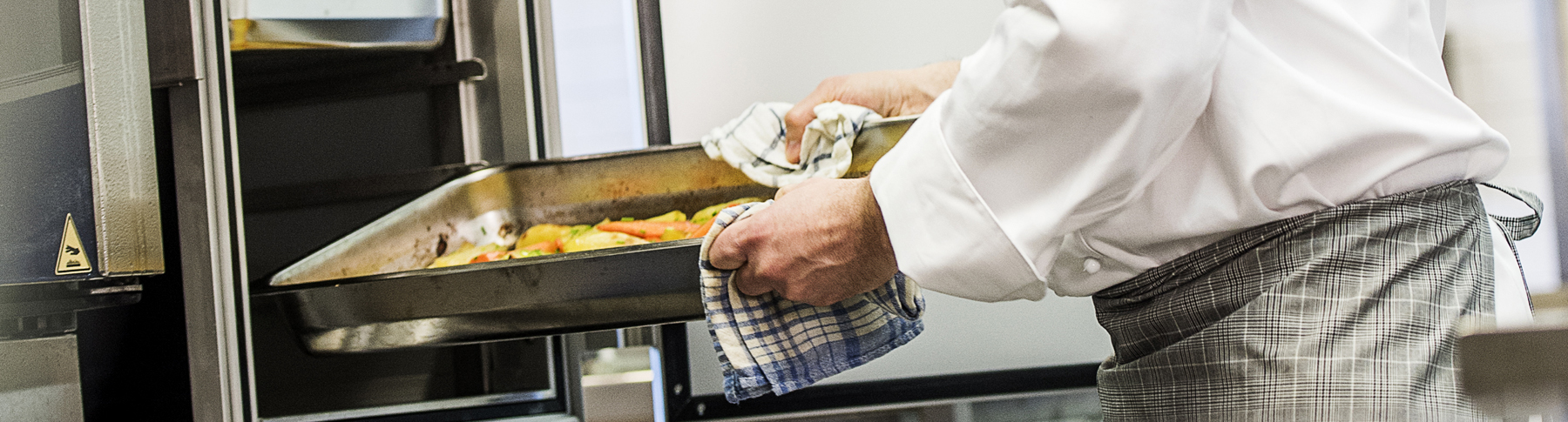 Chef loading food tray into a ScanBox food cart