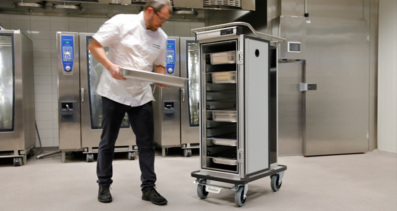 Male chef removing food tray from ScanBox unit